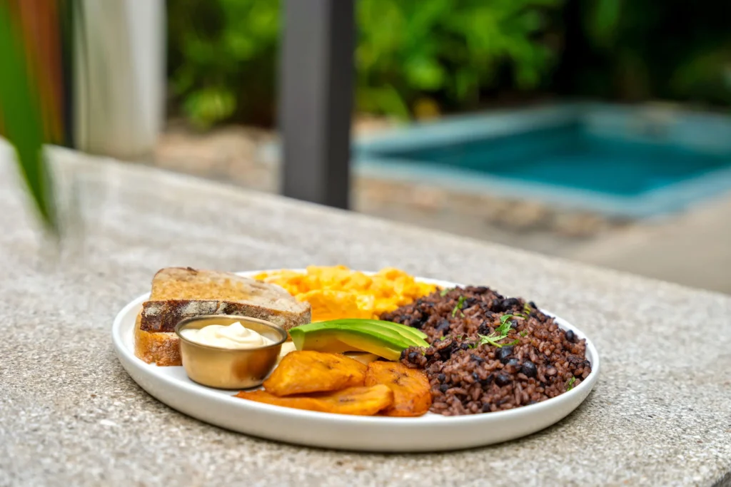 Traditional Costa Rican breakfast plate with gallo pinto, plantains and eggs at Selvatico Tamarindo Villas.